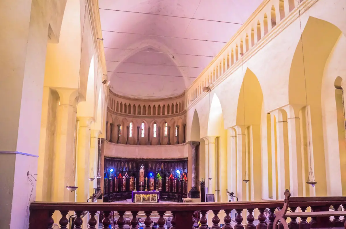 Interior of the Anglican cathedral with arches and a lit altar