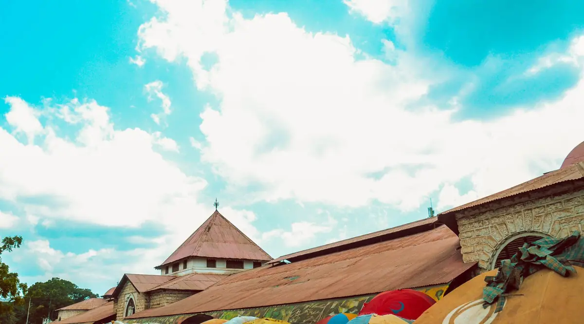 Roofs of the Darajani Market under a bright sky with colourful stalls
