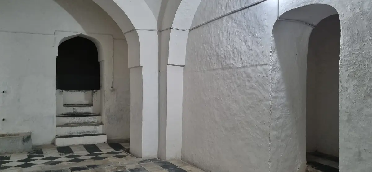 White arched room with steps in the Hamamni Persian Baths
