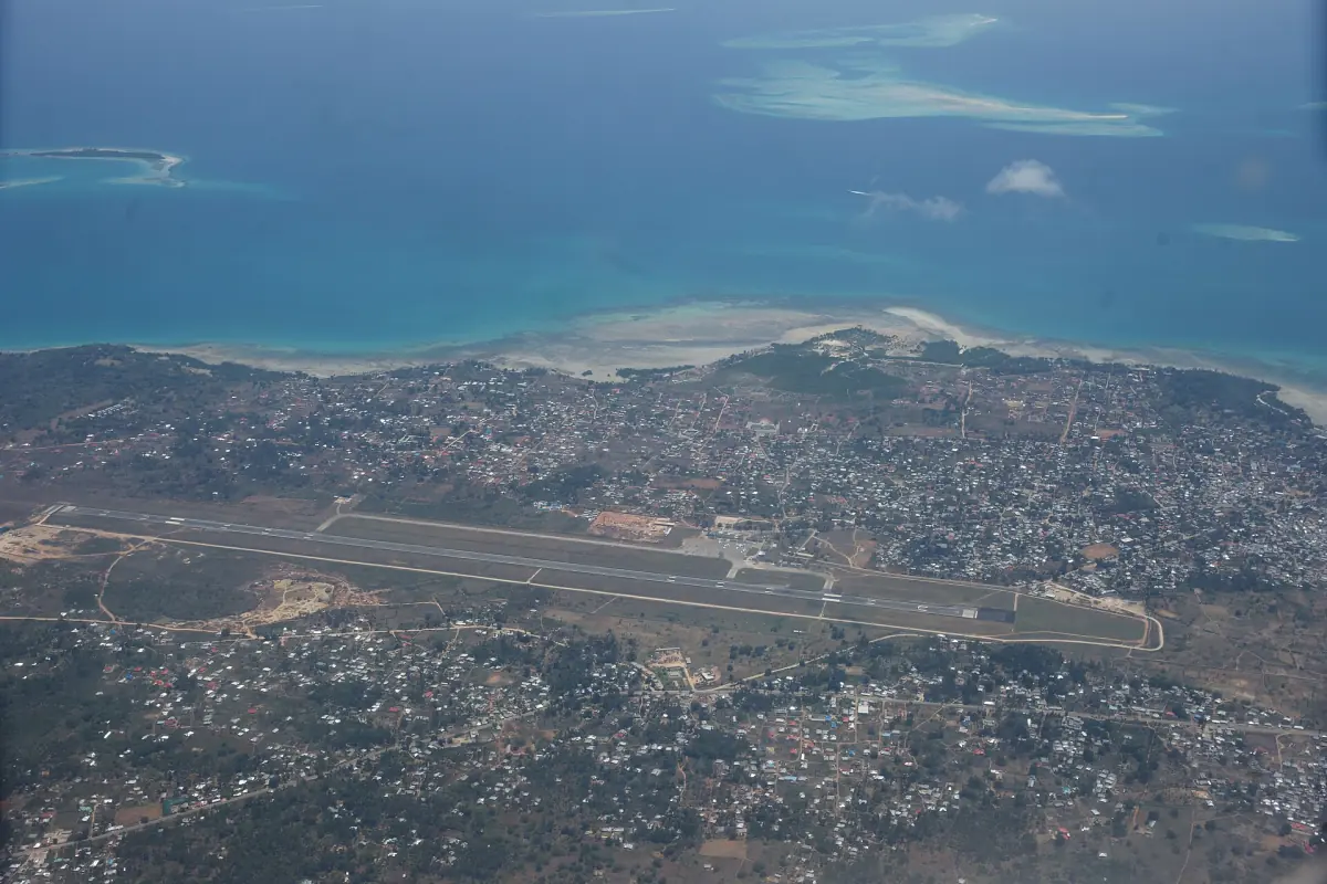 Aerial view of Zanzibar airport runway beside the town and the sea